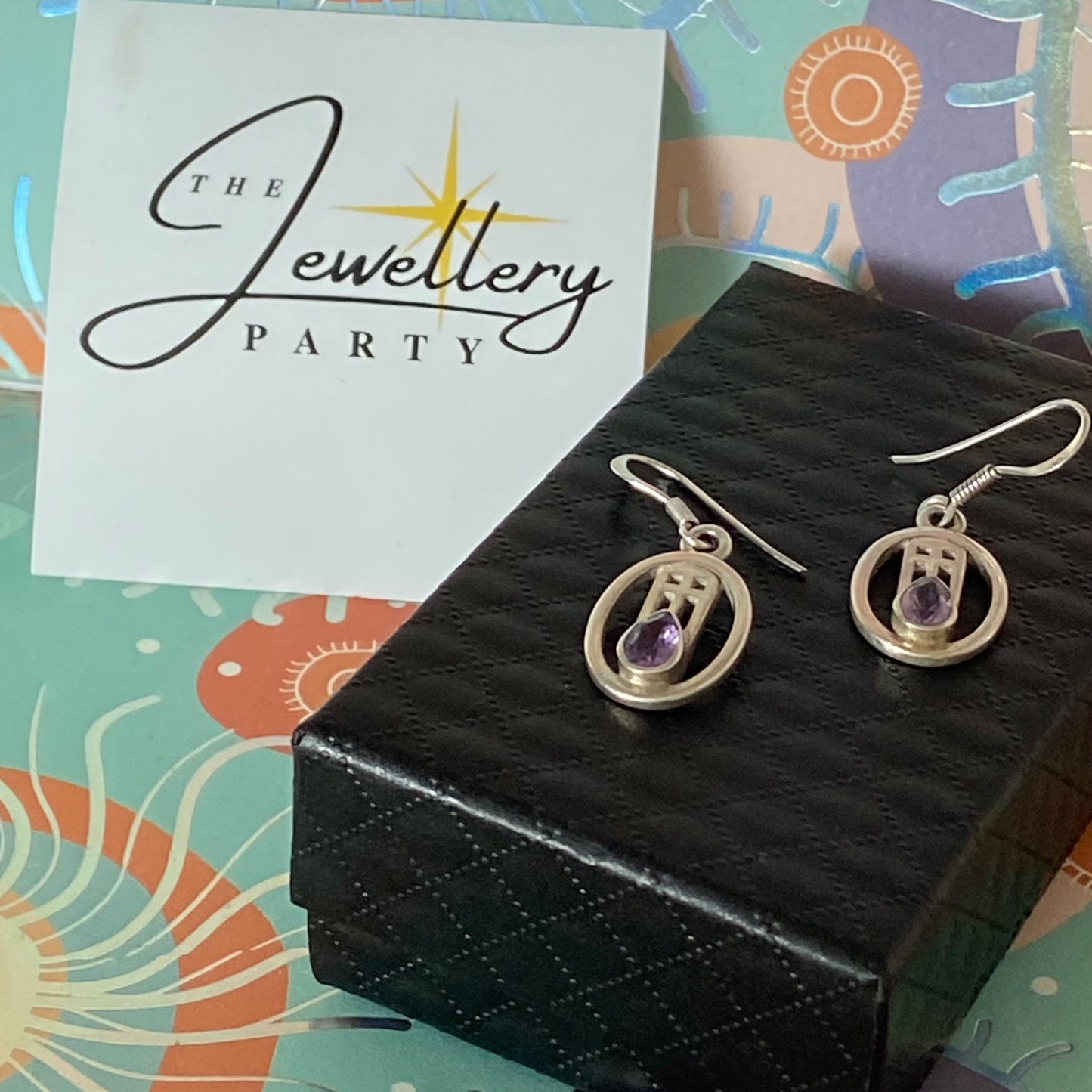 Sterling Silver lovely Earrings with a Purple Sparkly Stone