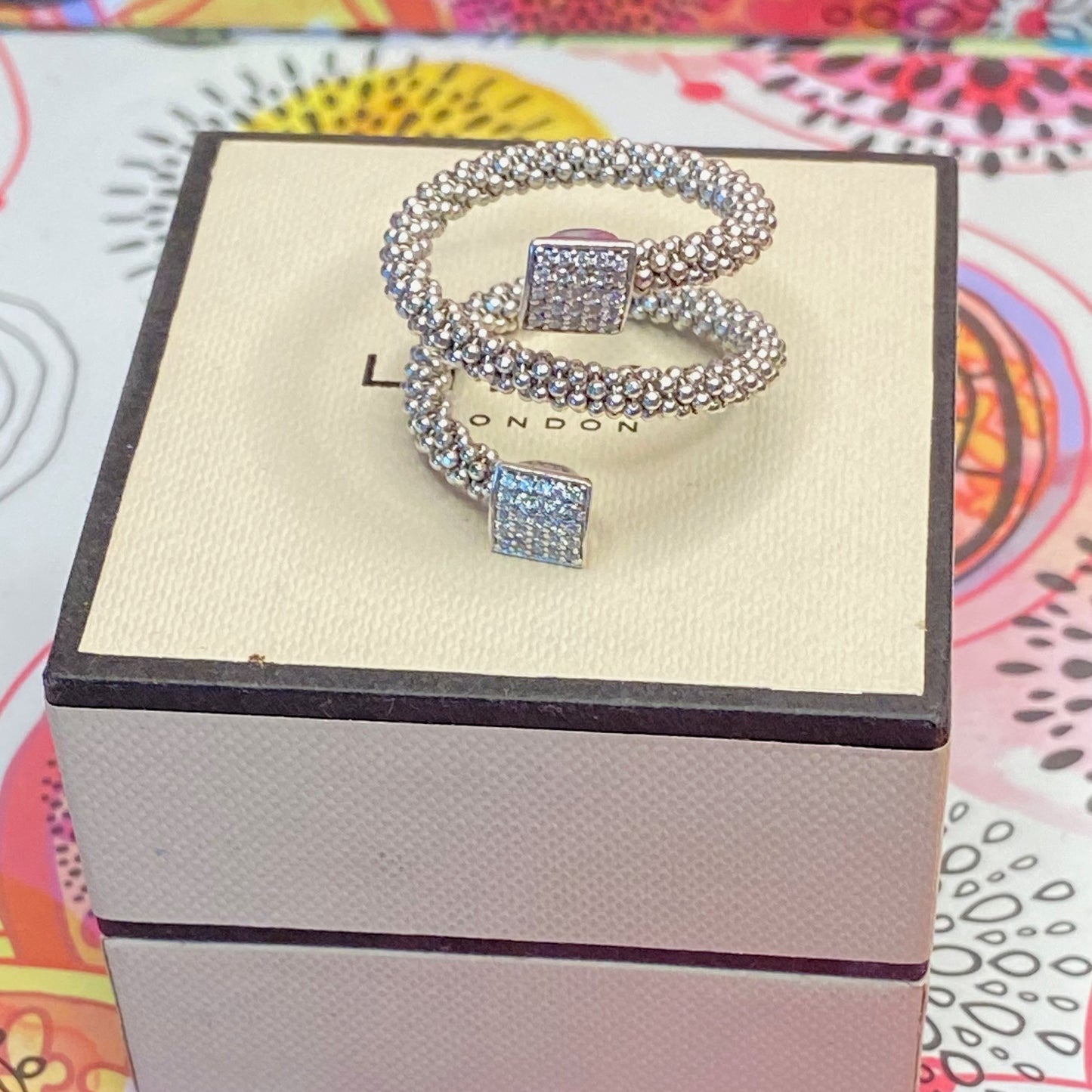 Links of London Sterling Silver Star Dust Wrap Ring with square barrels covered with Sparkly stones.