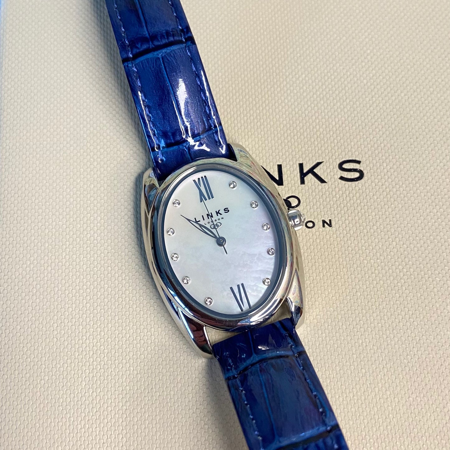 Rare Links of London Driver Ellipse Watch with Mother of pearl face, 10 Sapphire Crystals a Blue Real Leather Strap.