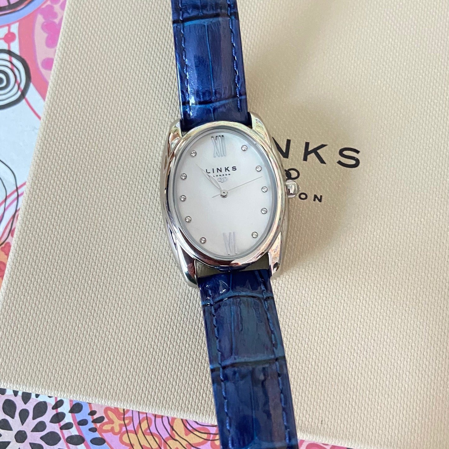 Rare Links of London Driver Ellipse Watch with Mother of pearl face, 10 Sapphire Crystals a Blue Real Leather Strap.