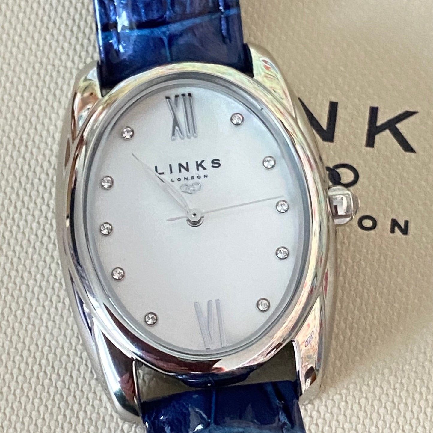 Rare Links of London Driver Ellipse Watch with Mother of pearl face, 10 Sapphire Crystals a Blue Real Leather Strap.