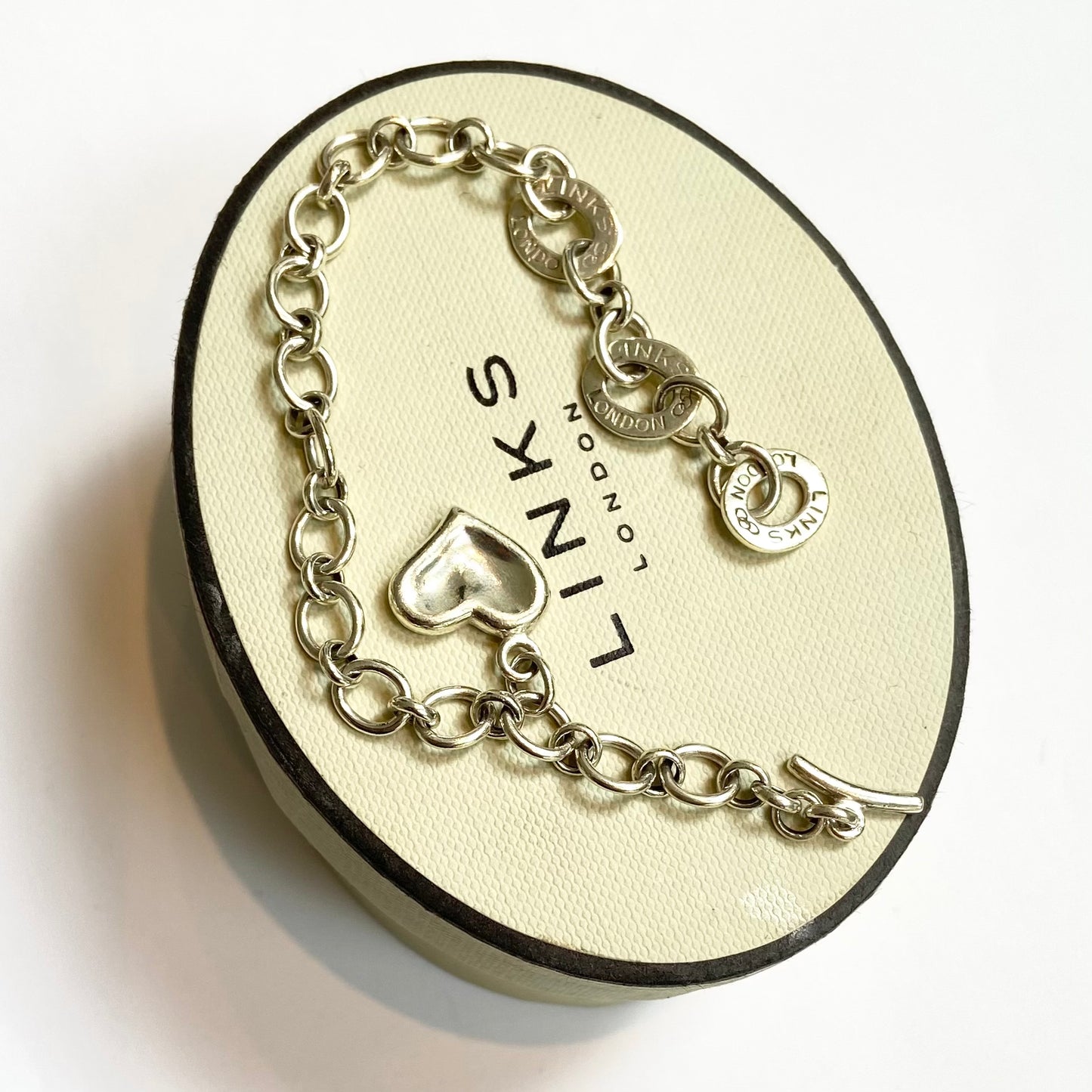Pre Loved Links of London Silver Bracelet with 3 Links of London Links, Heart charm and T Bar Clasp.