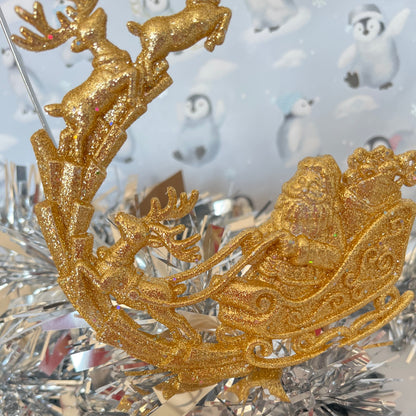 Sparkling, glitter-dusted gold reindeer and Santa sleigh hanging Christmas tree decoration.