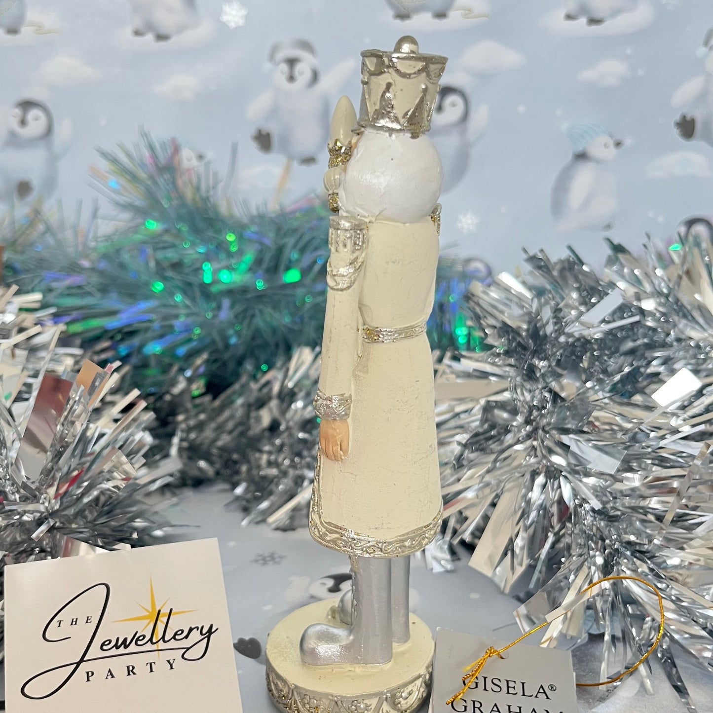 Gisela Graham cream and silver nutcracker figurine holding a staff.