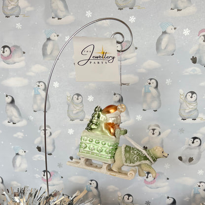 festive tabletop ornament features Santa riding a sleigh