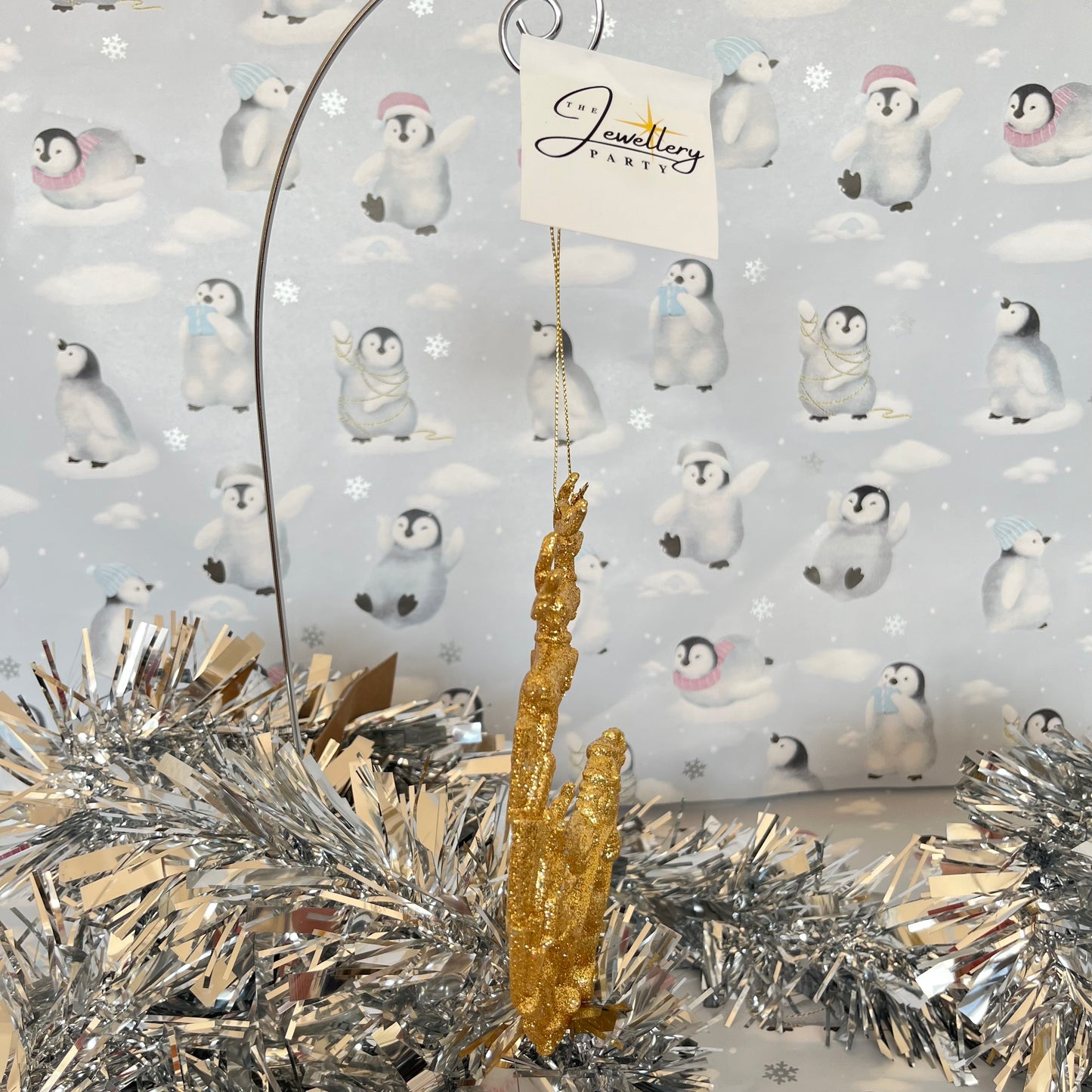 Sparkling, glitter-dusted gold reindeer and Santa sleigh hanging Christmas tree decoration.