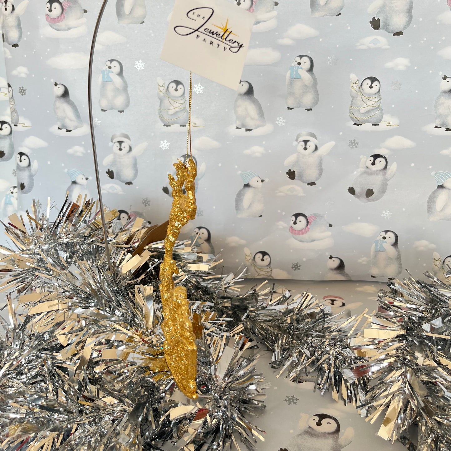 Sparkling, glitter-dusted gold reindeer and Santa sleigh hanging Christmas tree decoration.