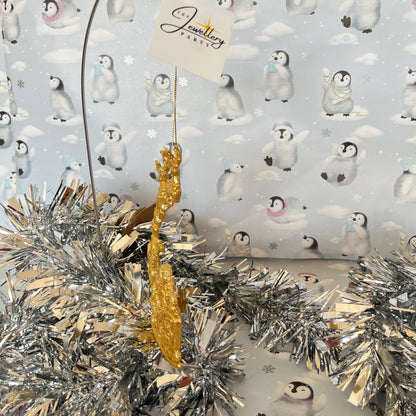 Sparkling, glitter-dusted gold reindeer and Santa sleigh hanging Christmas tree decoration.
