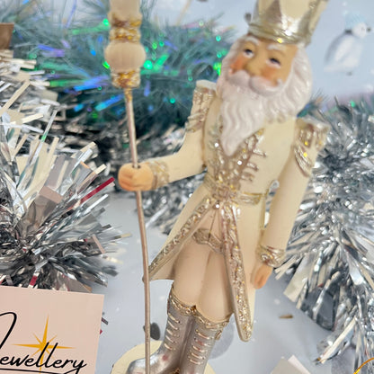 Gisela Graham cream and silver nutcracker figurine holding a staff.