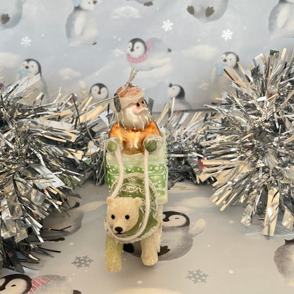 festive tabletop ornament features Santa riding a sleigh
