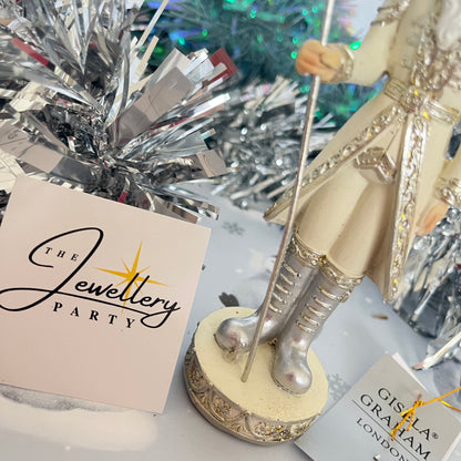 Gisela Graham cream and silver nutcracker figurine holding a staff.