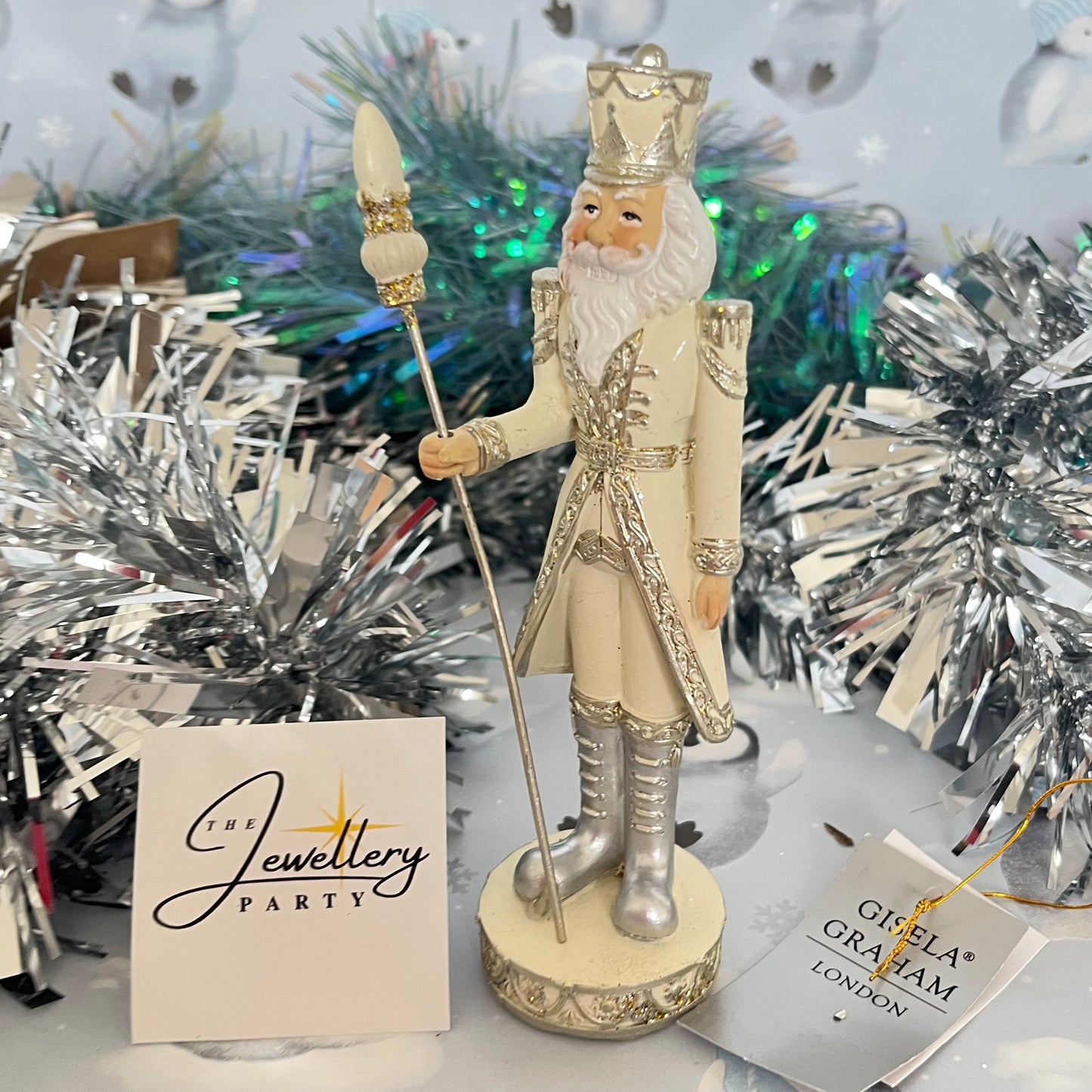 Gisela Graham cream and silver nutcracker figurine holding a staff.