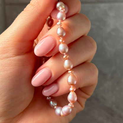 Stunning Pink Cultured Freshwater Pearl Bracelet with a delicate 9ct gold clasps securing it perfectly.  Hallmarked 375 on the clasp presented in a beautiful wooden box