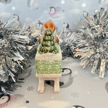festive tabletop ornament features Santa riding a sleigh