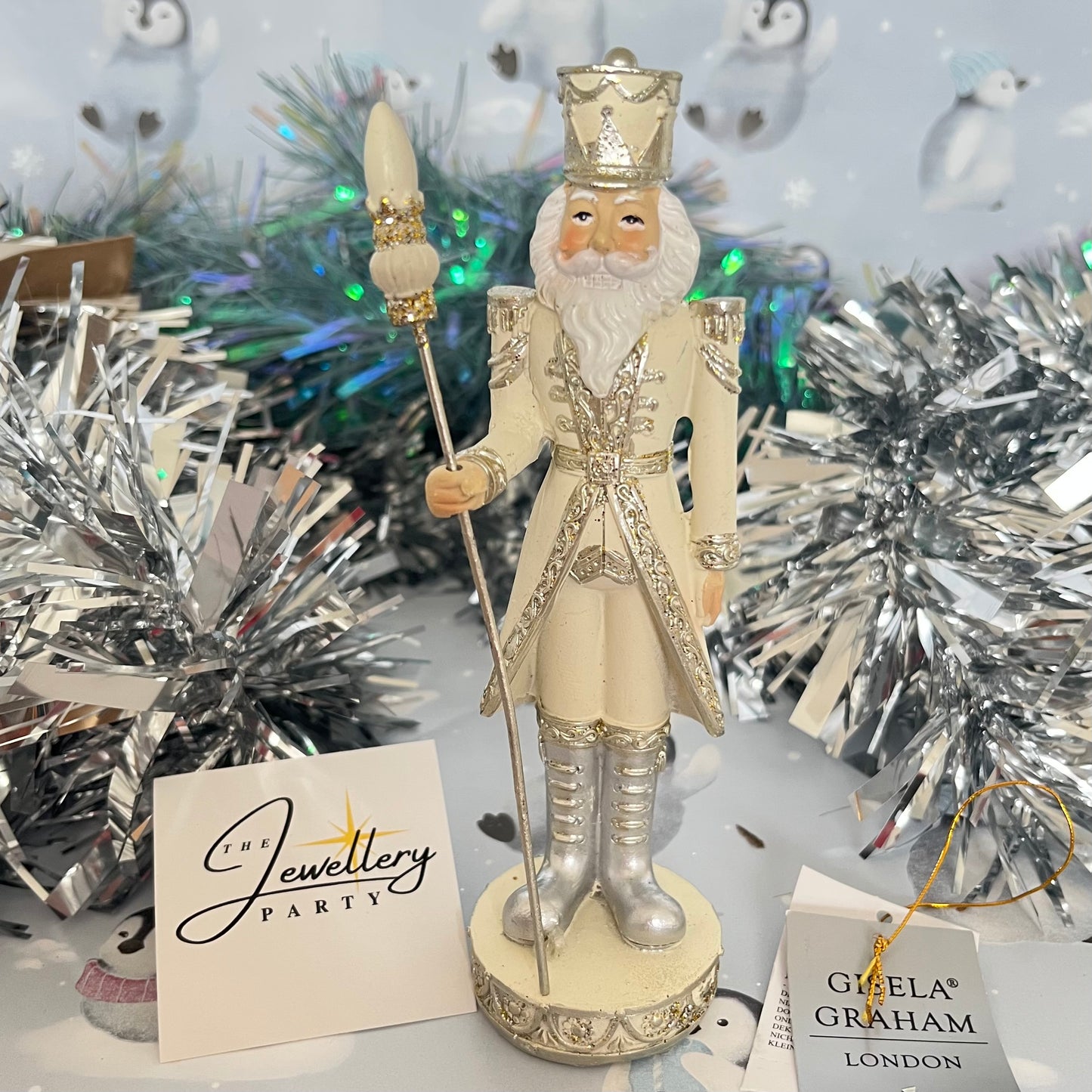 Gisela Graham cream and silver nutcracker figurine holding a staff.