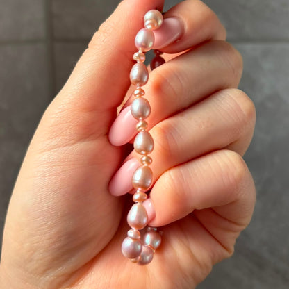 Stunning Pink Cultured Freshwater Pearl Bracelet with a delicate 9ct gold clasps securing it perfectly.  Hallmarked 375 on the clasp presented in a beautiful wooden box