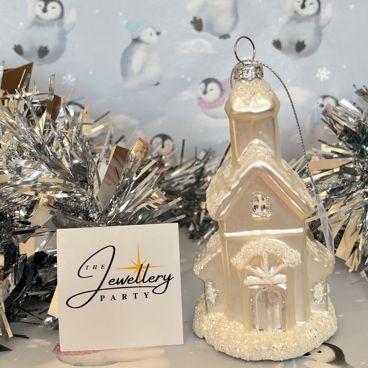 shimmering  champagne glass church Christmas ornament accented with sparkling glitter snow details