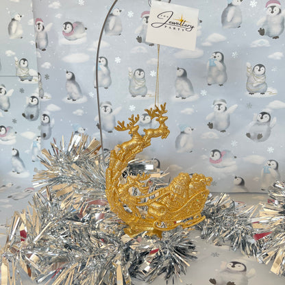 Sparkling, glitter-dusted gold reindeer and Santa sleigh hanging Christmas tree decoration.
