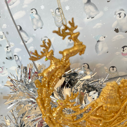 Sparkling, glitter-dusted gold reindeer and Santa sleigh hanging Christmas tree decoration.