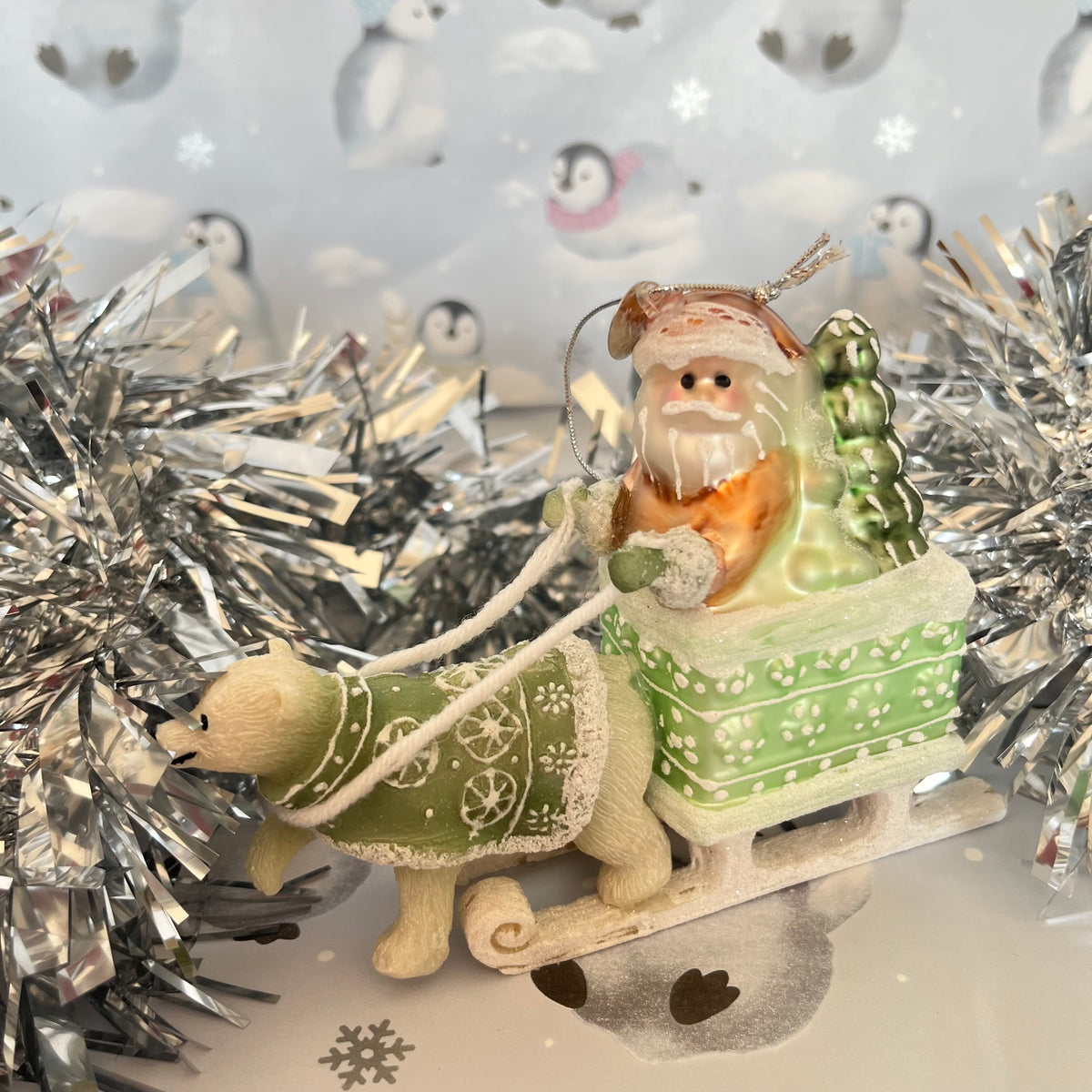 festive tabletop ornament features Santa riding a sleigh