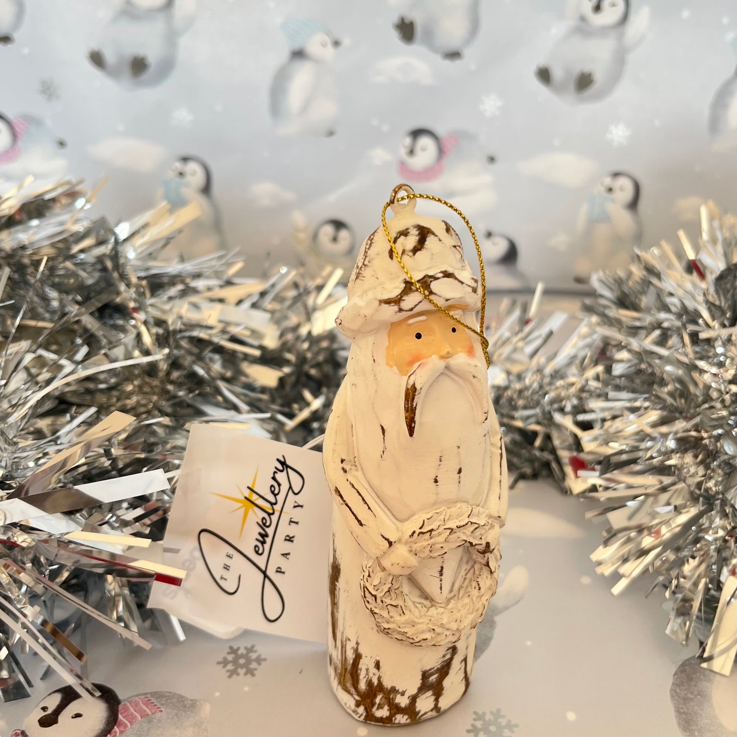 Natural Distressed Effect Carved Santa hanging ornament holding a festive wreath
