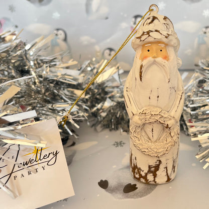 Natural Distressed Effect Carved Santa hanging ornament holding a festive wreath