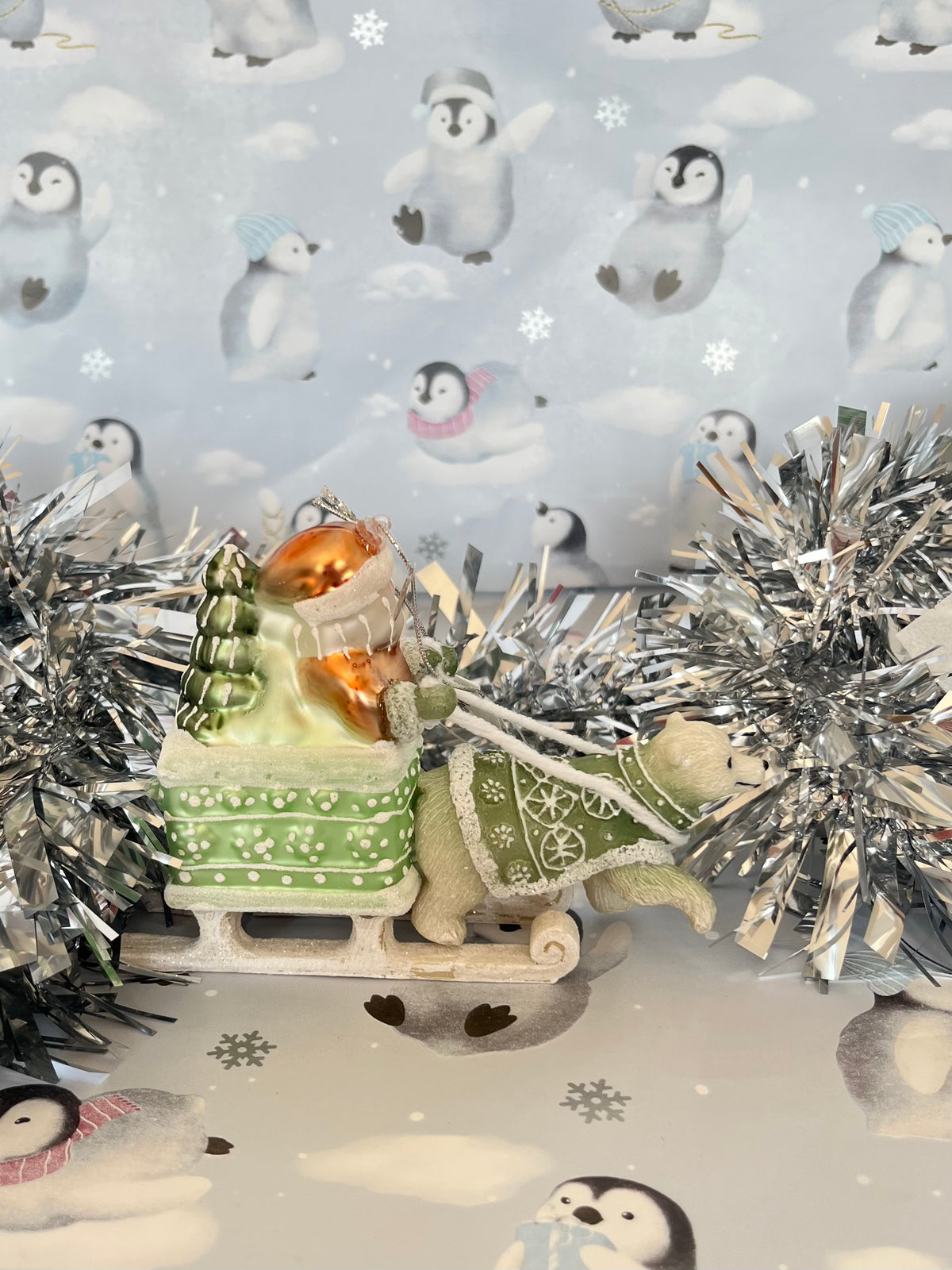 festive tabletop ornament features Santa riding a sleigh