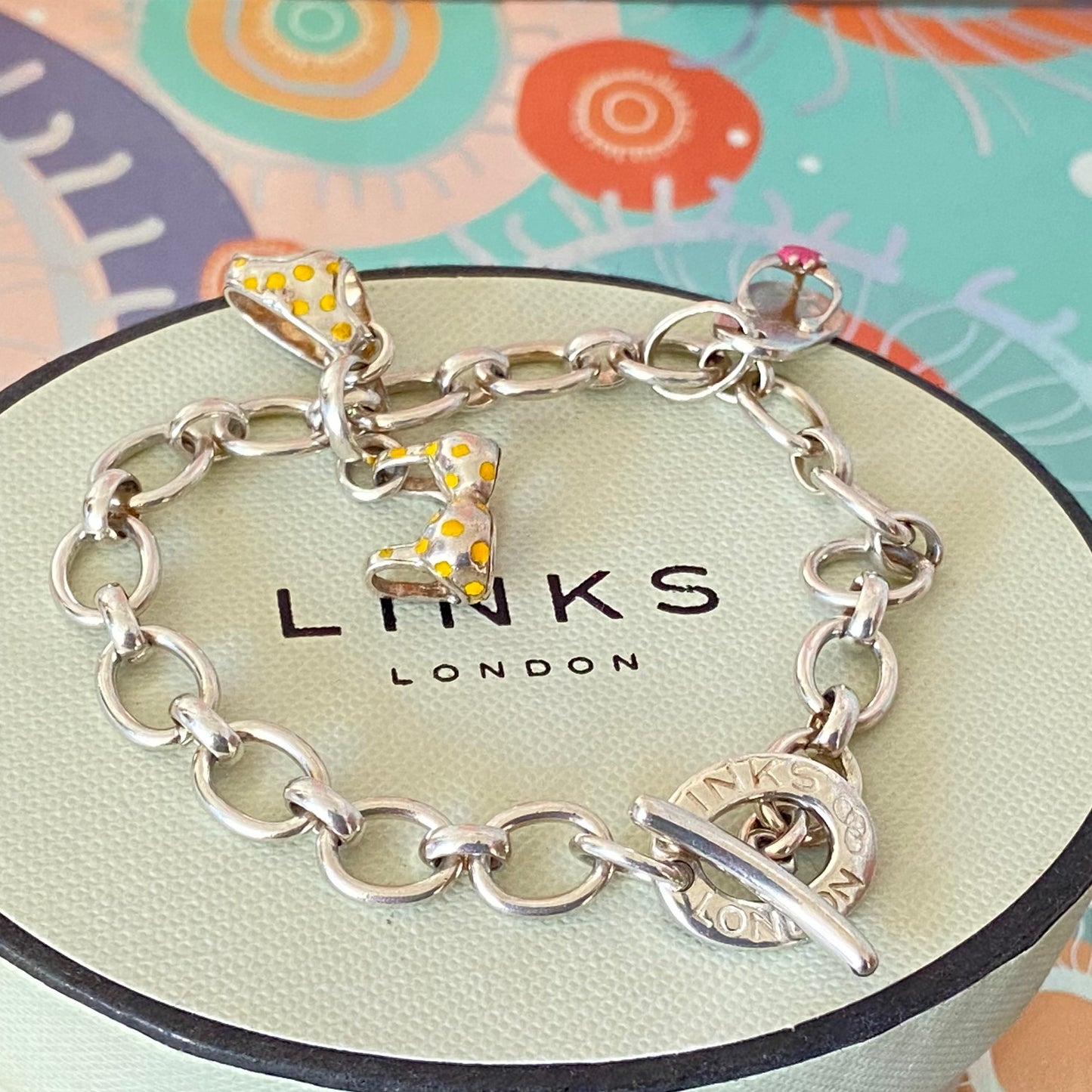 Links of London T-Bar Signature Bracelet with a Flip Flop and Yellow Polka Dot Bikini.