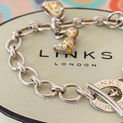 Links of London T-Bar Signature Bracelet with a Flip Flop and Yellow Polka Dot Bikini.