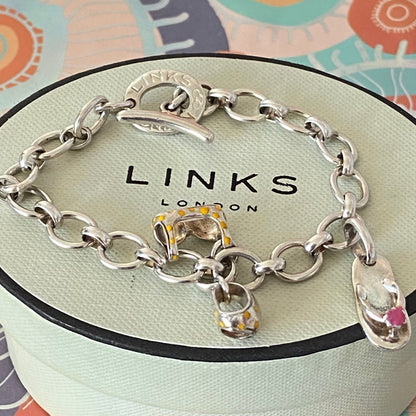 Links of London T-Bar Signature Bracelet with a Flip Flop and Yellow Polka Dot Bikini.