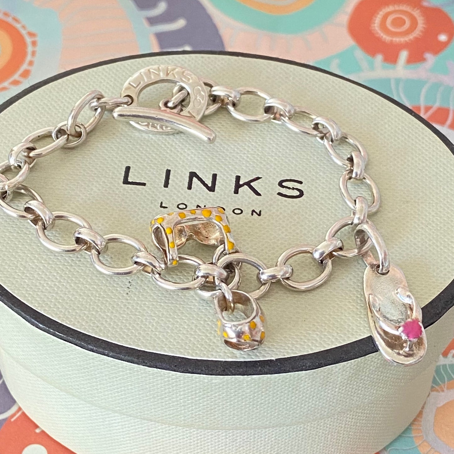 Links of London T-Bar Signature Bracelet with a Flip Flop and Yellow Polka Dot Bikini.