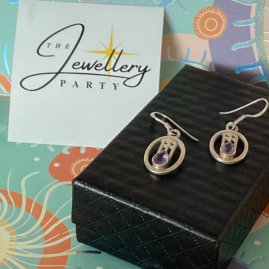 Sterling Silver lovely Earrings with a Purple Sparkly Stone