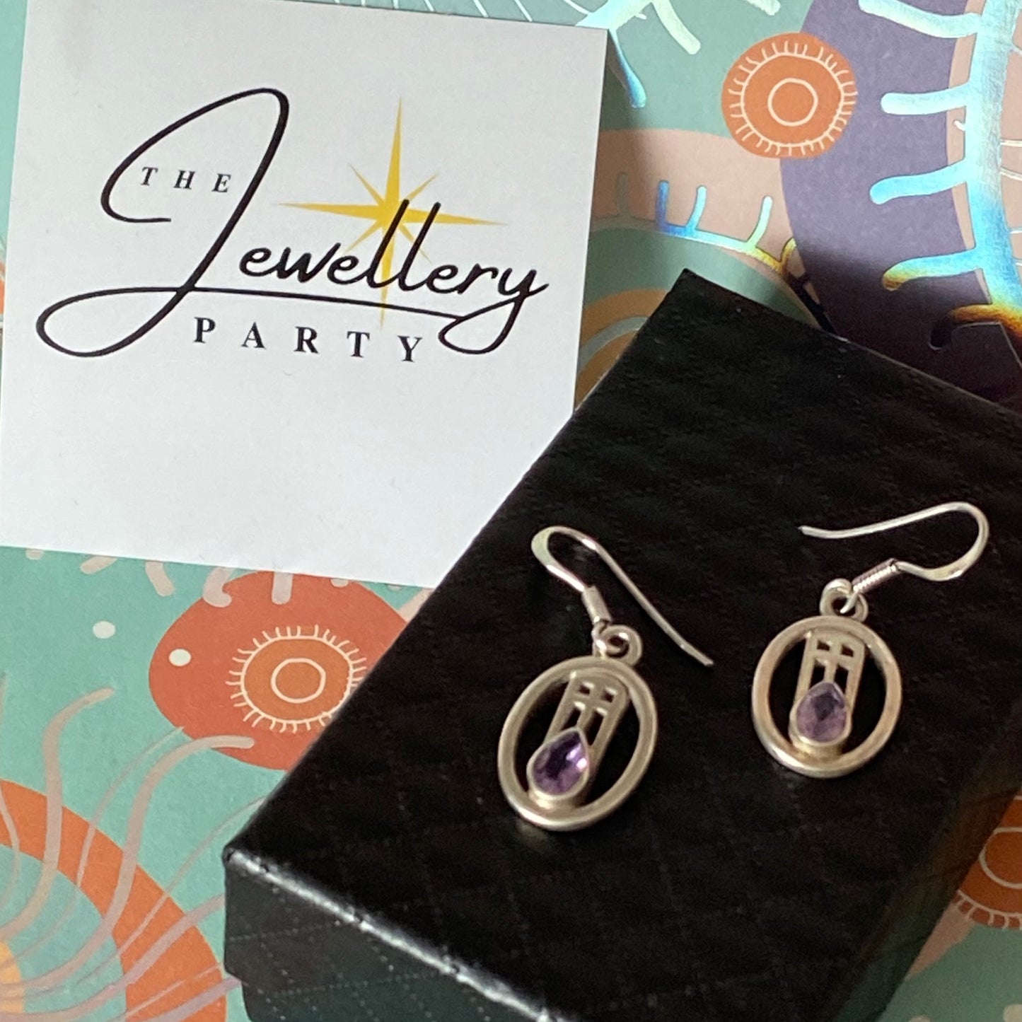 Sterling Silver lovely Earrings with a Purple Sparkly Stone