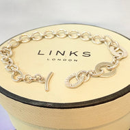 Links of London Sterling Silver Bracelet with 3 Links of London Links with a T Bar Clasp.