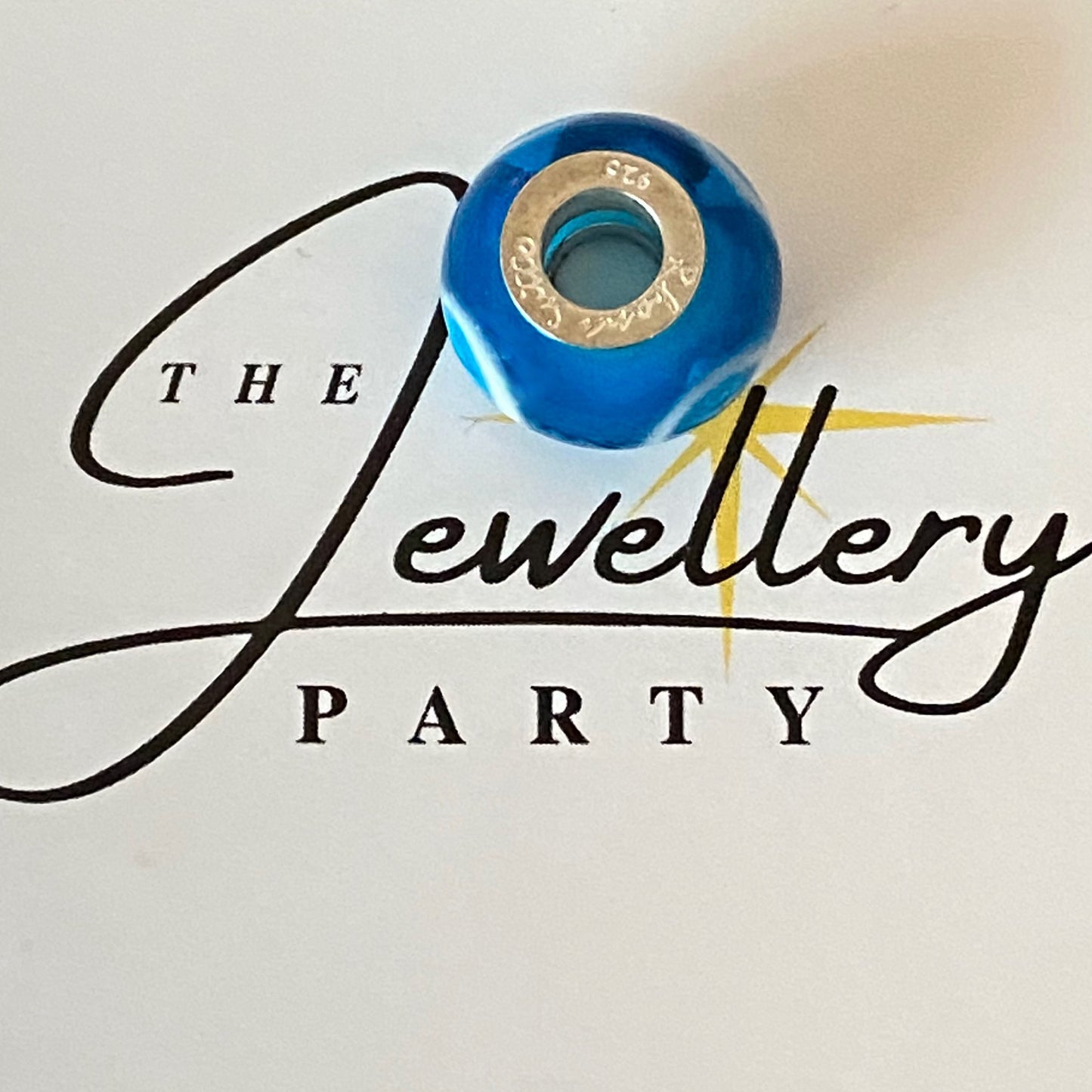 Blue Glass charm with circles by Rhona Sutton Crafted in Sterling Silver and Glass.