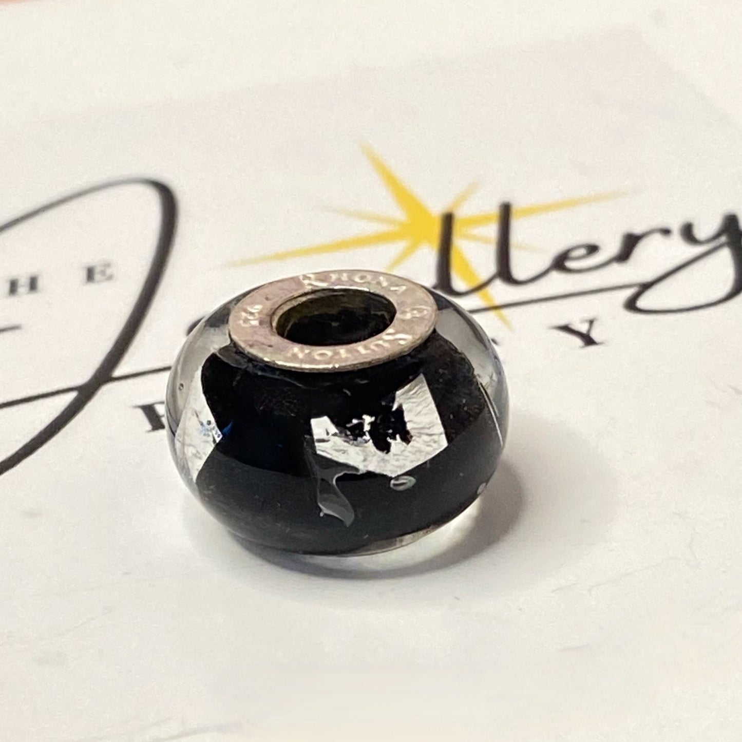 Black Glass charm with Silver stamps Design by Rhona Sutton Crafted in Sterling Silver and Glass.