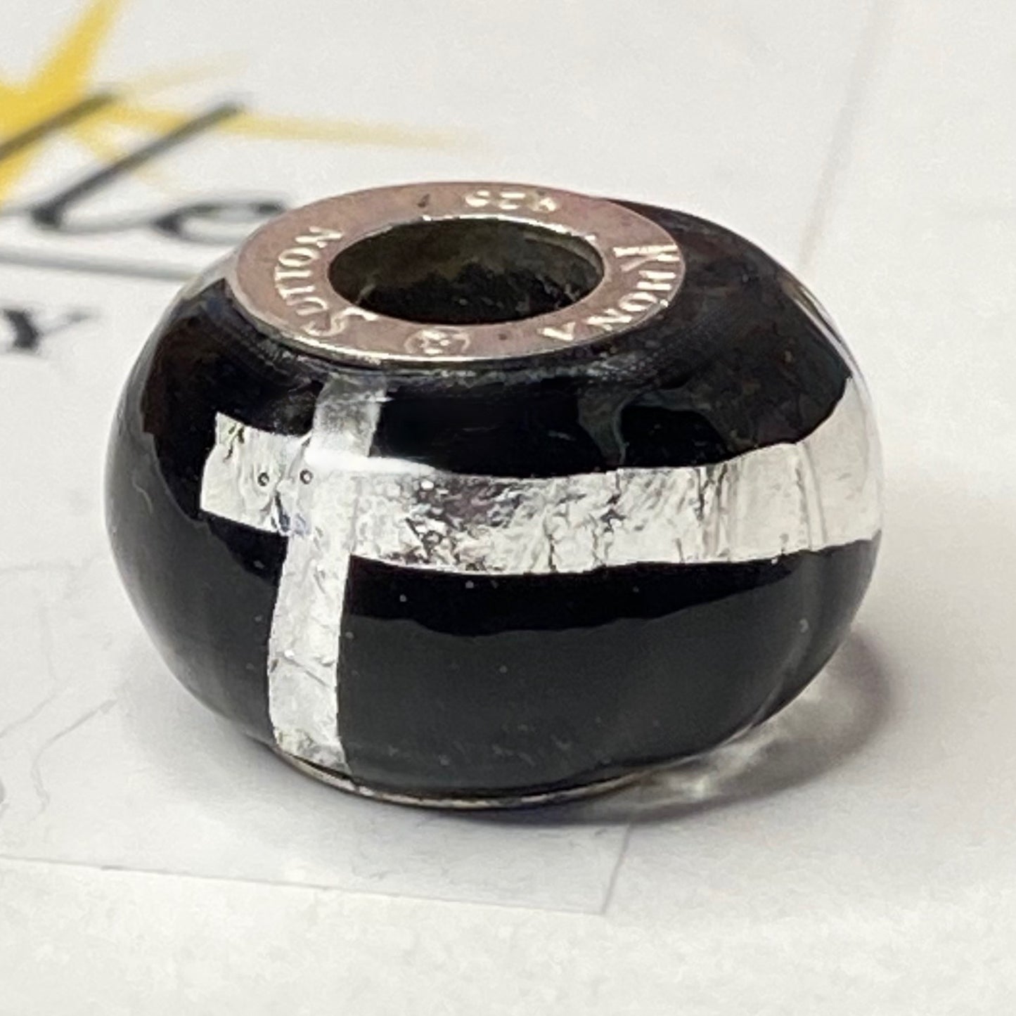 Black charm with Silver Stripe and cross Design by Rhona Sutton Crafted in Sterling Silver