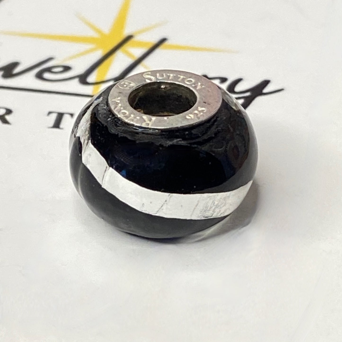 Black charm with Silver Stripe and cross Design by Rhona Sutton Crafted in Sterling Silver