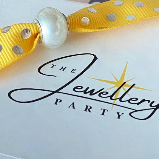 Pearl effect charm with Silver stamps Design by Rhona Sutton Crafted in Sterling Silver and Glass.