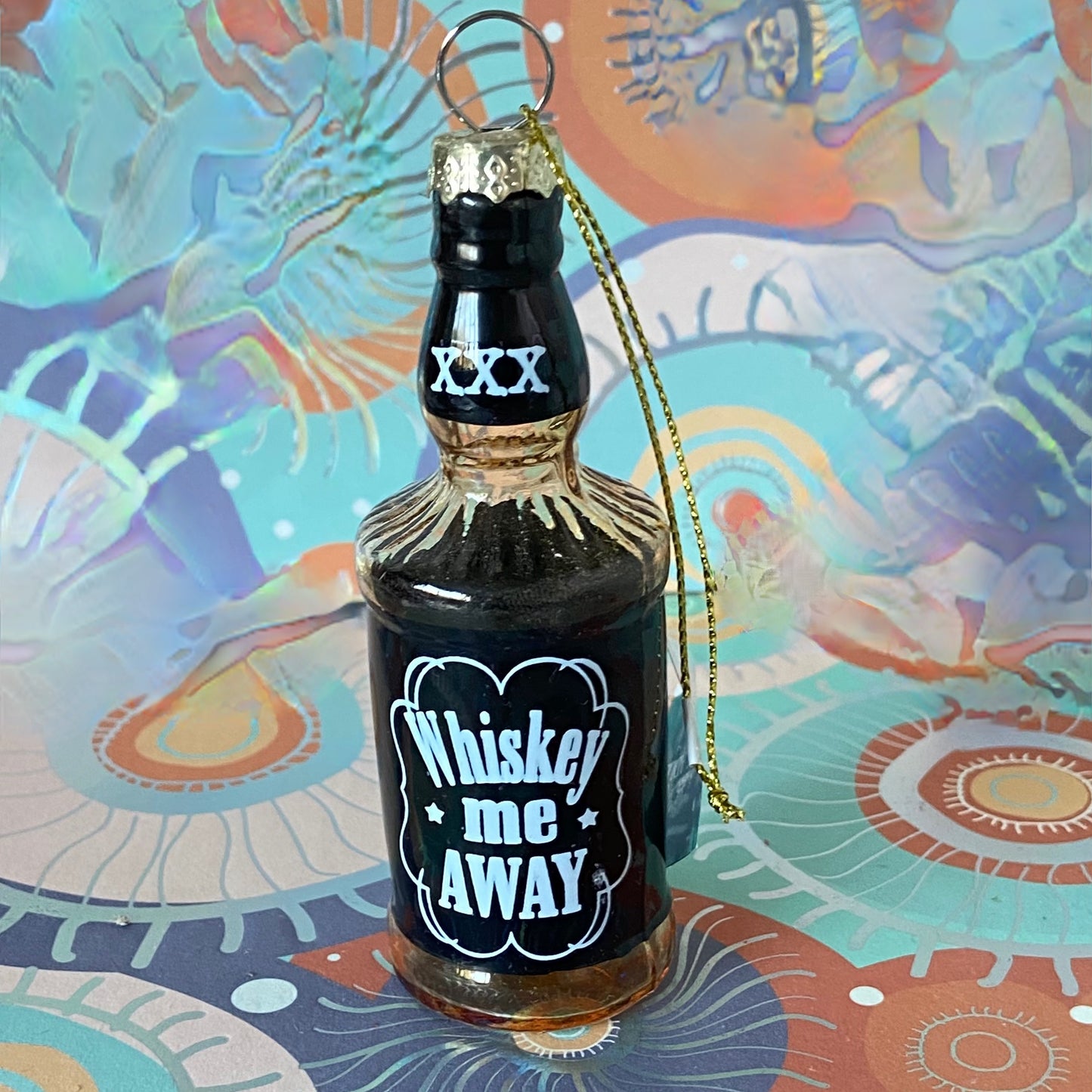 The item is a glass "Whiskey me AWAY" Christmas ornament, often manufactured by brands like Cody Foster & Co. or Kurt Adler.