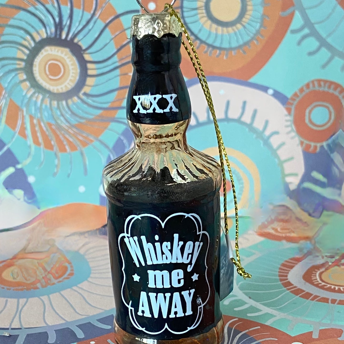 The item is a glass "Whiskey me AWAY" Christmas ornament, often manufactured by brands like Cody Foster & Co. or Kurt Adler.