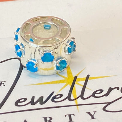925 sterling silver charm with blue gemstones, featuring the hallmark maker's mark TGGC.