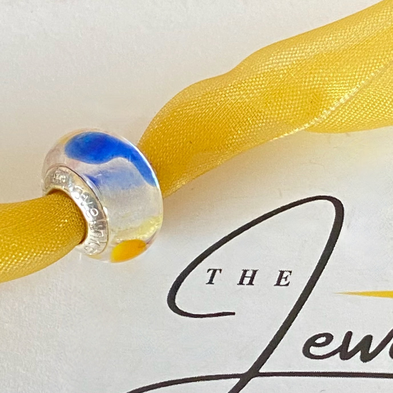 LoveLinks white  Bead design with dashes of yellow, blue and orange Crafted from Sterling Silver and Murano Glass