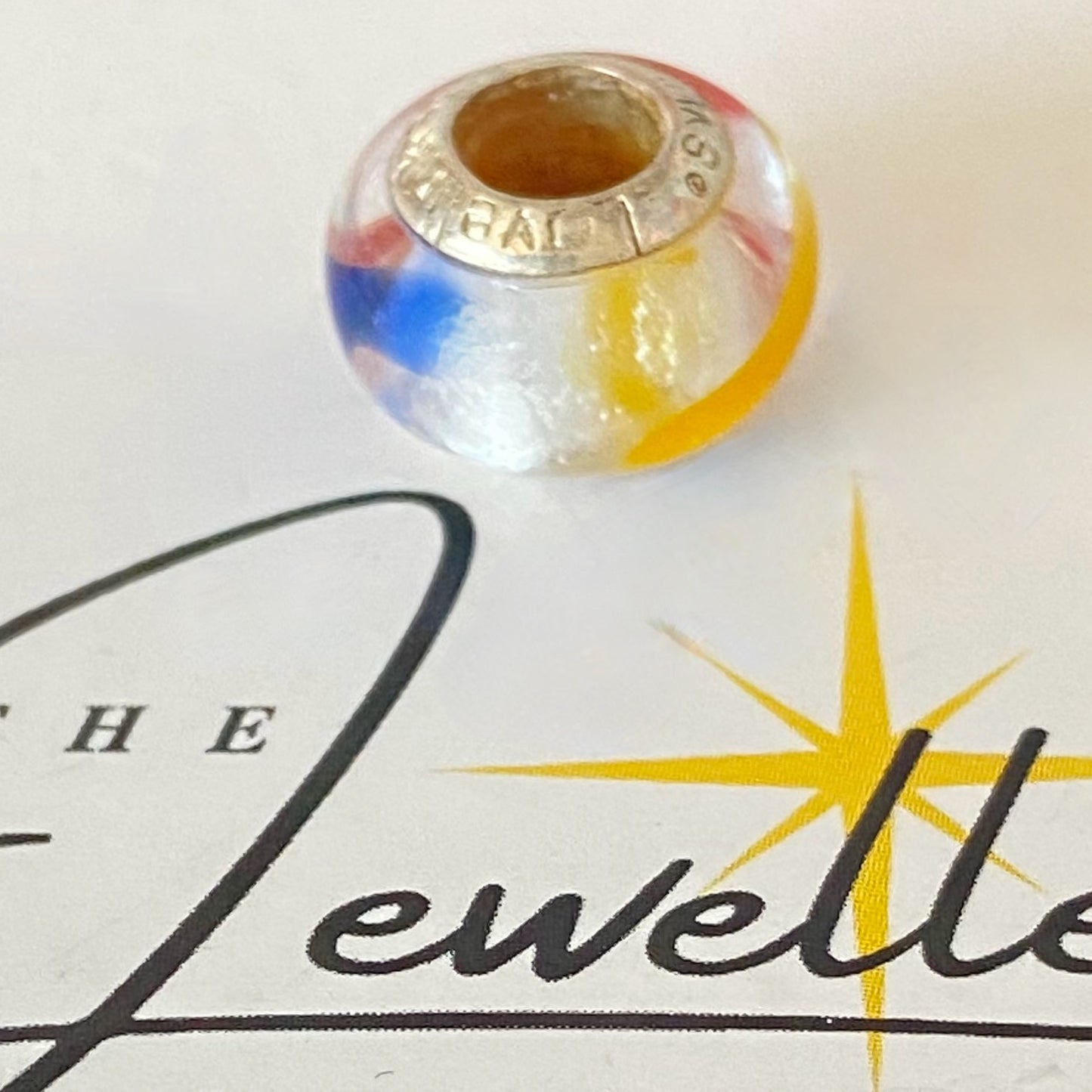 LoveLinks white  Bead design with dashes of yellow, blue and orange Crafted from Sterling Silver and Murano Glass