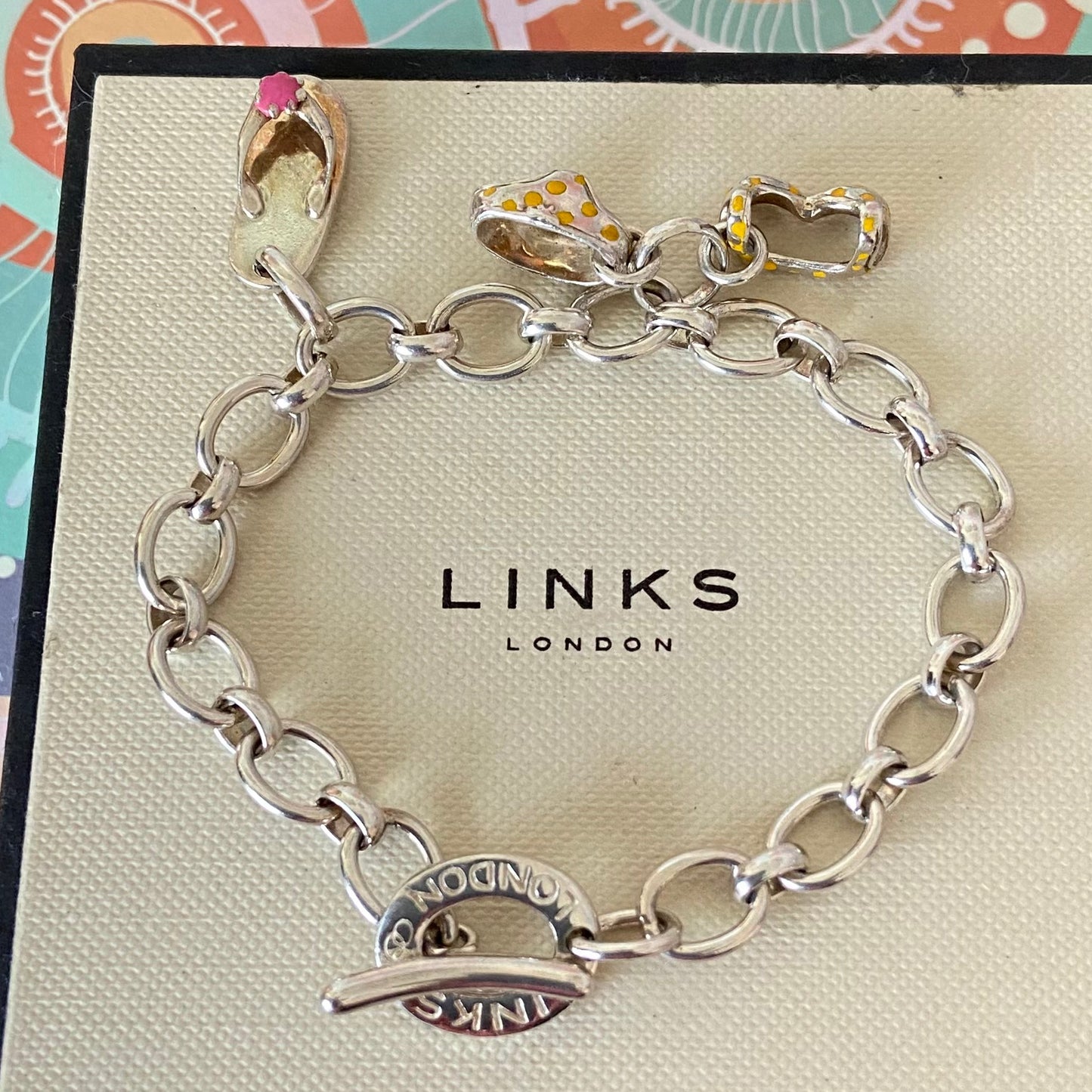 Links of London T-Bar Signature Bracelet with a Flip Flop and Yellow Polka Dot Bikini.