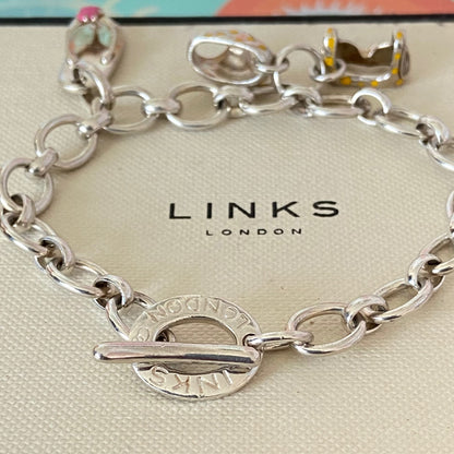 Links of London T-Bar Signature Bracelet with a Flip Flop and Yellow Polka Dot Bikini.