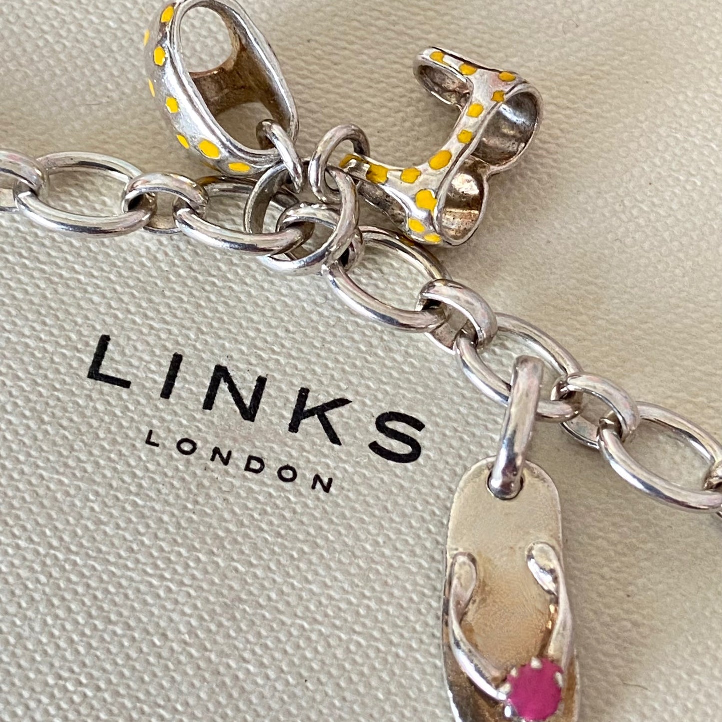Links of London T-Bar Signature Bracelet with a Flip Flop and Yellow Polka Dot Bikini.
