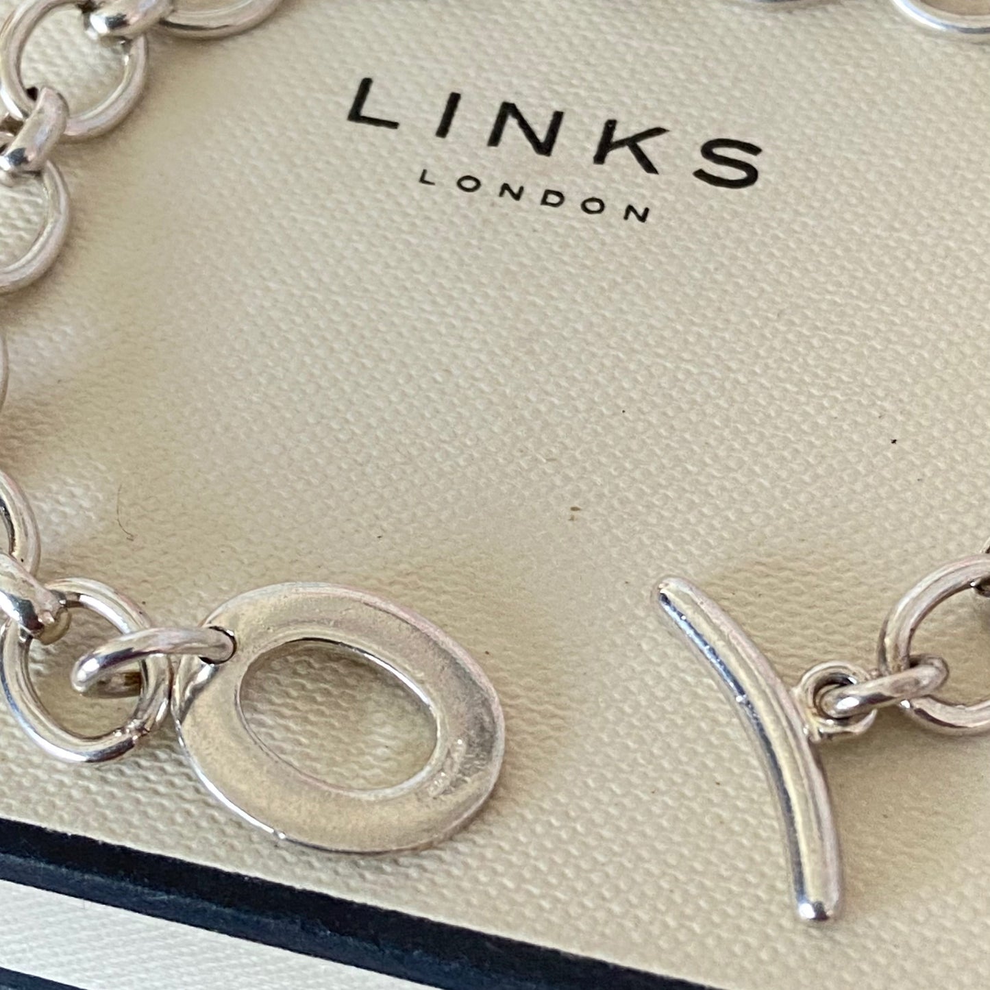 Links of London T-Bar Signature Bracelet with a Flip Flop and Yellow Polka Dot Bikini.