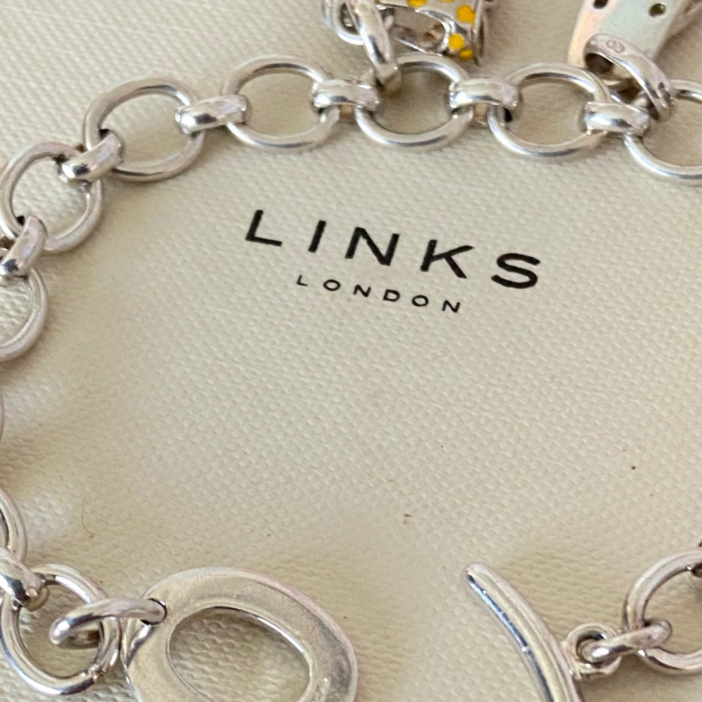 Links of London T-Bar Signature Bracelet with a Flip Flop and Yellow Polka Dot Bikini.