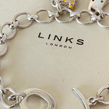 Links of London T-Bar Signature Bracelet with a Flip Flop and Yellow Polka Dot Bikini.